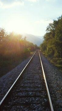 Sunny scenery, drone flying above railroad, vertical short video 
