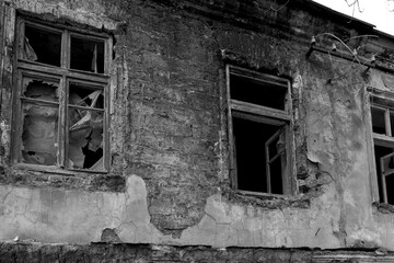 Fototapeta na wymiar Old destroyed houses. War, destruction, restructuring. abandoned, useless houses. Restitution, bombing, consequences of social and military conflicts. Legacy of the collapse of the USSR