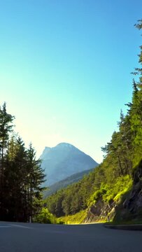 Green nature, POV car drive, mountain road, sunny day, vertical short video, social media travel story
