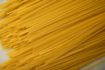 dry pasta close-up on a white marble surface. macro photo of raw pasta. whole grain spaghetti pasta top view
