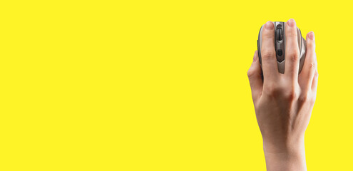 Hand lying on computer mouse, op view. Ad yellow banner, background with copy space for text