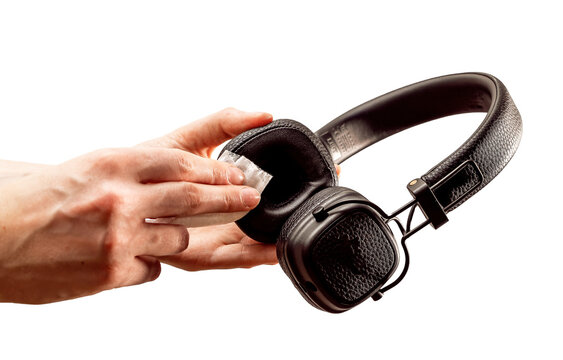 Cleaning Black Headphones With Wet Wiper Isolated On White