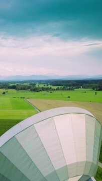Stormy sky above green fields, satellite communication antenna, vertical footage