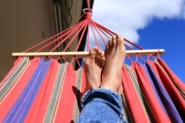 Relaxing in hammock, detail shot under beautiful blue sky