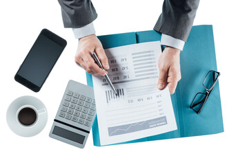 Business man checking a financial report