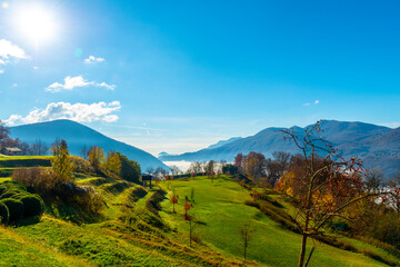 Mountain View over Lake Lugano with Cloudscape and Sunlight in Lugano, Ticino in Switzerland.