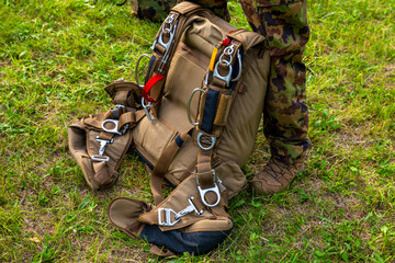 Military Parachuter Standing on the Grass with His Parachute in Switzerland.