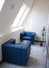 Blue armchairs in the recreation area in the office center
