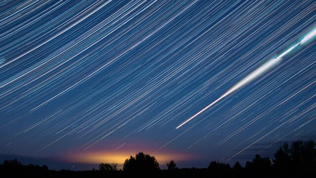 Dramatic Night Sky With Glowing Stars Trails And Meteoric Tracks Trails Rotate Above Countryside Rural Landscape. Time Lapse, Time-lapse. 4k Timelapse Amazing Stars Effect In Sky.