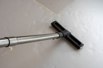 Prepping the Concrete Floor: Vacuuming Sand and Dust Before Applying Plastic Covering,
