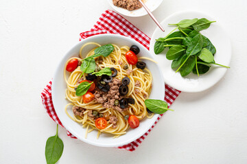 Tuna pasta spaghetti with cherry tomatoes food top view and spinach greens