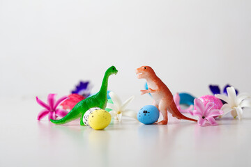 Toys of dinosaurs and Easter eggs, flowers  holiday concept