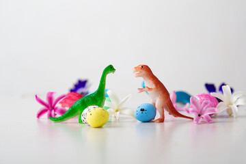 Toys of dinosaurs and Easter eggs, flowers  holiday concept © Olha Afanasieva