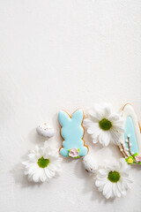 Overhead view of Easter bunny cookies holiday concept white flowers copy space