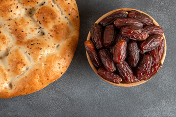 Date fruits,traditional ramadan pita on black background
