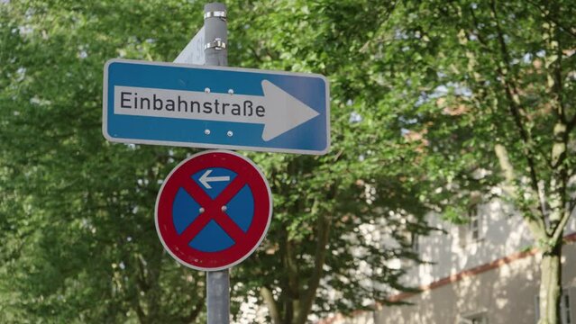 One way street sign (Einbnahnstrase on German) in Germany against urban background.