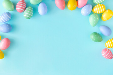 Easter background concept. Top view set of various colorful easter eggs on isolated pastel blue...