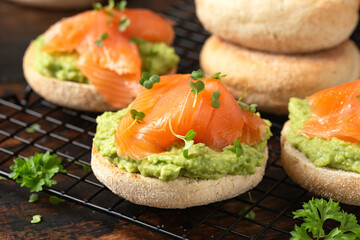 Fresh English Muffins with avocado and salmon. Healthy morning breakfast food