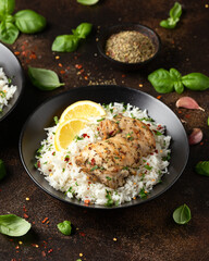 Grilled Chicken thighs served with rice in a black bowl