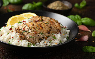 Grilled Chicken thighs served with rice in a black bowl