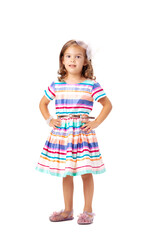 happy little girl wearing colorful dress posing in studio, isolated on white