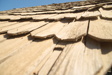 old wooden roof against a blue sky