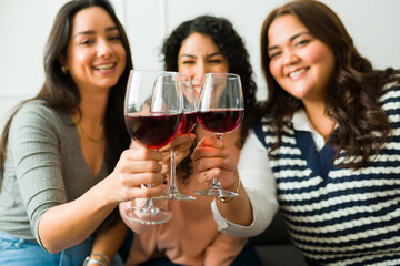 Cheerful friends drinking wine having fun