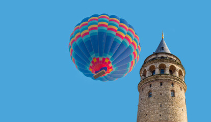 Fototapeta na wymiar Hot air balloon flying over Galata tower - Istanbul, Turkey