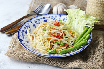 Somtum, Thai spicy papaya salad on white background, international Thai food Known and popular, made with papaya and tomatoes, it tastes sour, sweet and spicy.
