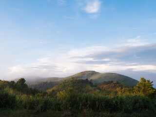 a scenic view of green mountains and fog at Thong Pha Phum National Park in Kanchanaburi, Thailand.