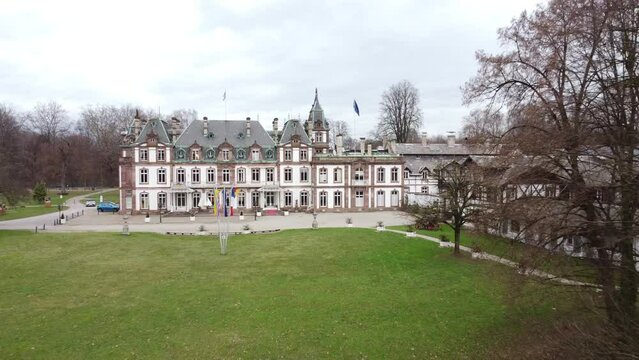 A French castle or large mansion filmed in the French countryside in the gray winter. The castle has the same vibe as Downton Abbey and exudes old money attitude.