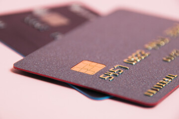 Bank cards with modern chips on a pink background. Protection of bank cards from fraudsters