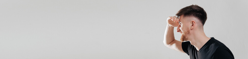 Obraz premium Profile portrait of young handsome man, guy with clean no acne face, one side, looks left and smiles happy and satisfied, standing against white background. banner