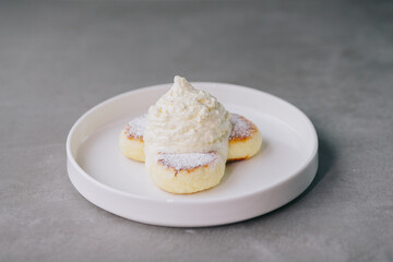 Cheese pancakes with Espuma on a plate
