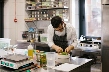 The chef prepares food in the modern spacious kitchen.