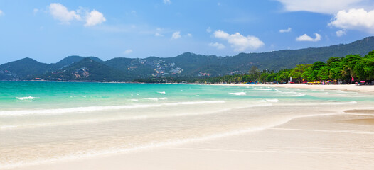 View of beautiful white sand beach with turquoise water of Chaweng beach, in Koh Samui, Thailand.