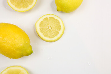 Full and sliced lemons on white background