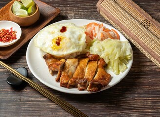 Chicken Drumstick Rice with egg and salad served in bowl isolated on table top view of taiwan food