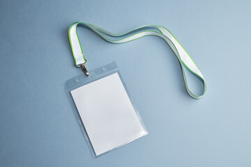Transparent badge mockup isolated on blue background. Plain empty name tag mock up with white string.