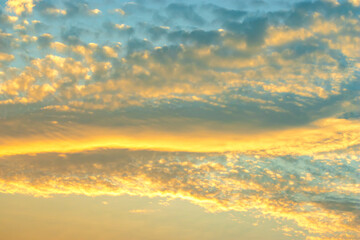 Naklejka na ściany i meble Clouds and evening golden sky, abstract background, copy space for text.