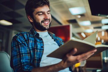 Positive man with notebook working