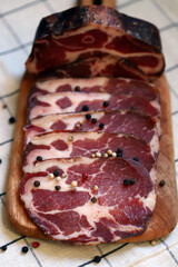 Capocollo. Italian ham slices on the board.