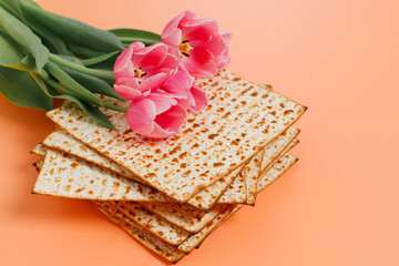 Matzo with tulips flowers. Pesach celebration concept (jewish Passover holiday)