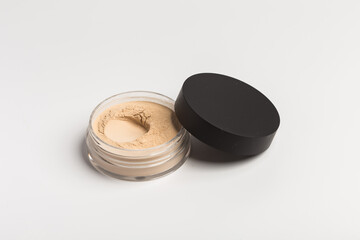 Mineral makeup powder isolated on white background. Light beige foundation powder. Skin tone face cosmetic product sample