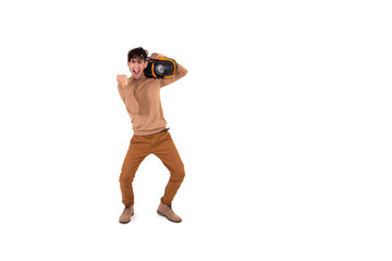 A young man listens to music through a tape recorder. White background. Isolate. Retro disco.