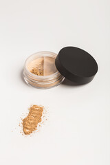 Mineral makeup powder twist seal sifter isolated on white background. Light beige foundation powder. Skin tone face cosmetic product sample