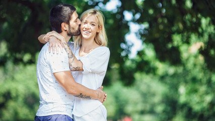 Fototapeta premium A happy family enjoying nature and having fun with their daughter