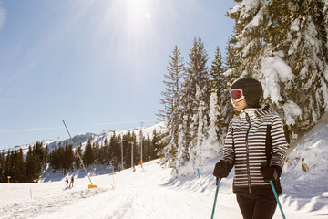 Young woman enjoing winter day of skiing fun in the snow