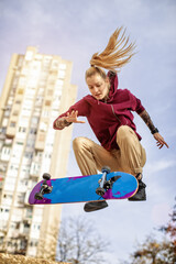 Female skater enjoys riding and jumping with her skate © Branimir