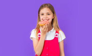 photo of teen girl eat yummy donut. teen girl with yummy donut isolated on purple.
